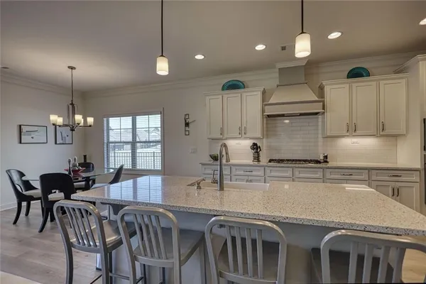a kitchen with stainless steel appliances granite countertop a kitchen island a stove and a sink