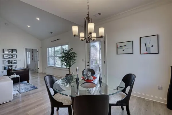 a view of a dining room with furniture and a chandelier