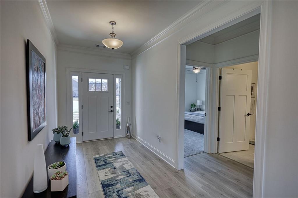 612 Haven Way Monroe, GA 30655 - Photo 19 of 44 a view of a hallway with wooden floor and a bathroom