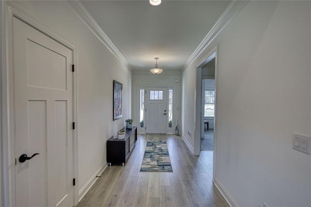 612 Haven Way Monroe, GA 30655 - Photo 21 of 44 a view of a hallway with wooden floor and furniture