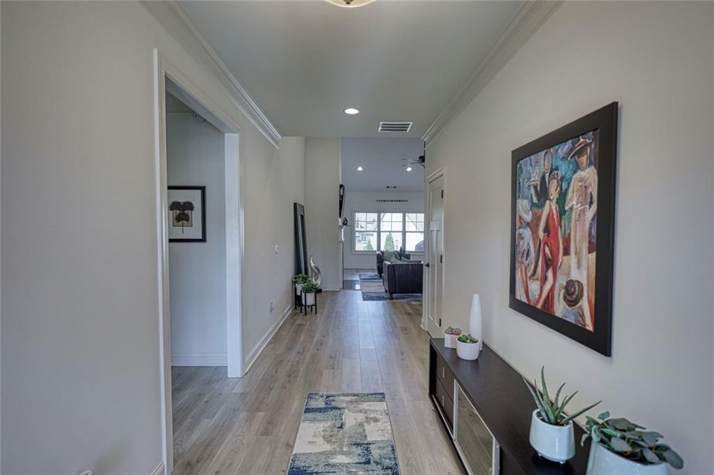 612 Haven Way Monroe, GA 30655 - Photo 22 of 44 a hallway with wooden floor windows and plants