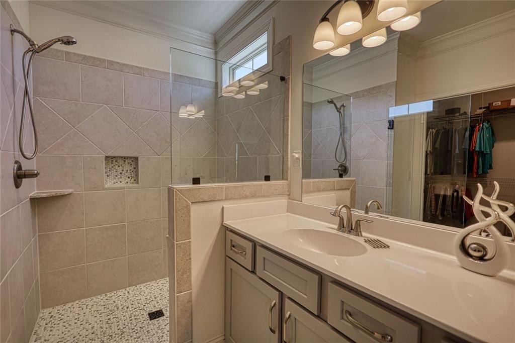 612 Haven Way Monroe, GA 30655 - Photo 26 of 44 a bathroom with a sink a vanity a shower and a mirror