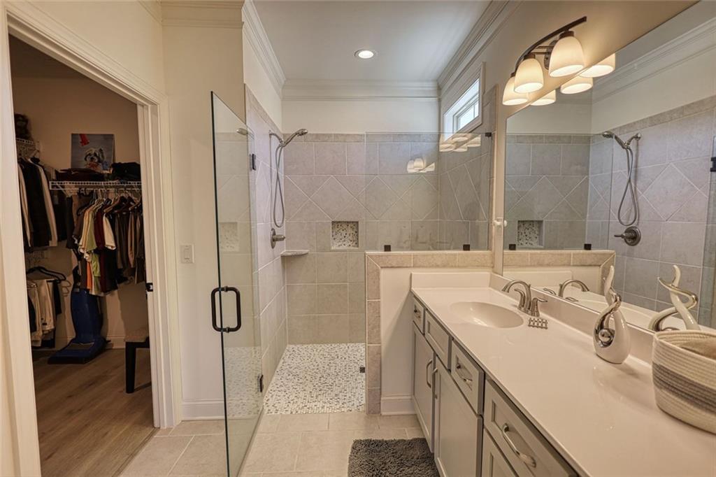 612 Haven Way Monroe, GA 30655 - Photo 27 of 44 a bathroom with a double vanity sink mirror and shower