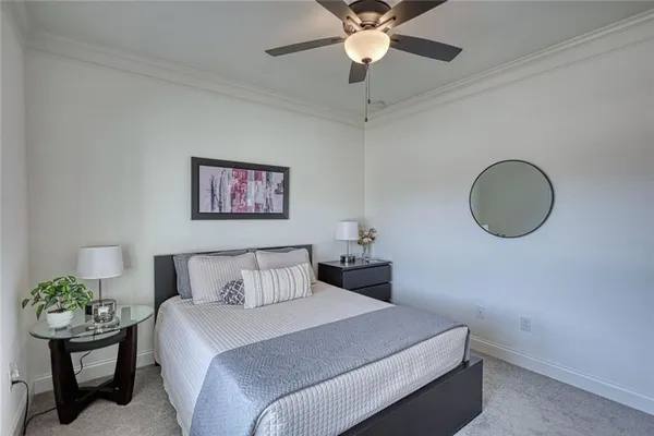 a bedroom with a large bed and a chandelier