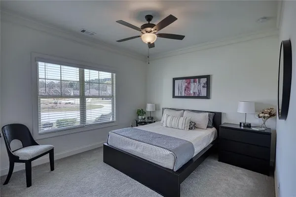 a bedroom with a bed and a large window