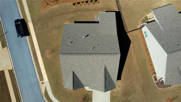 an aerial view of a house with a swimming pool