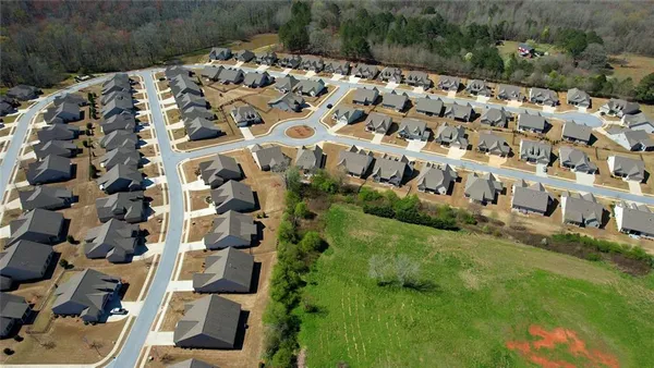 an aerial view of a backyard with table and chairs