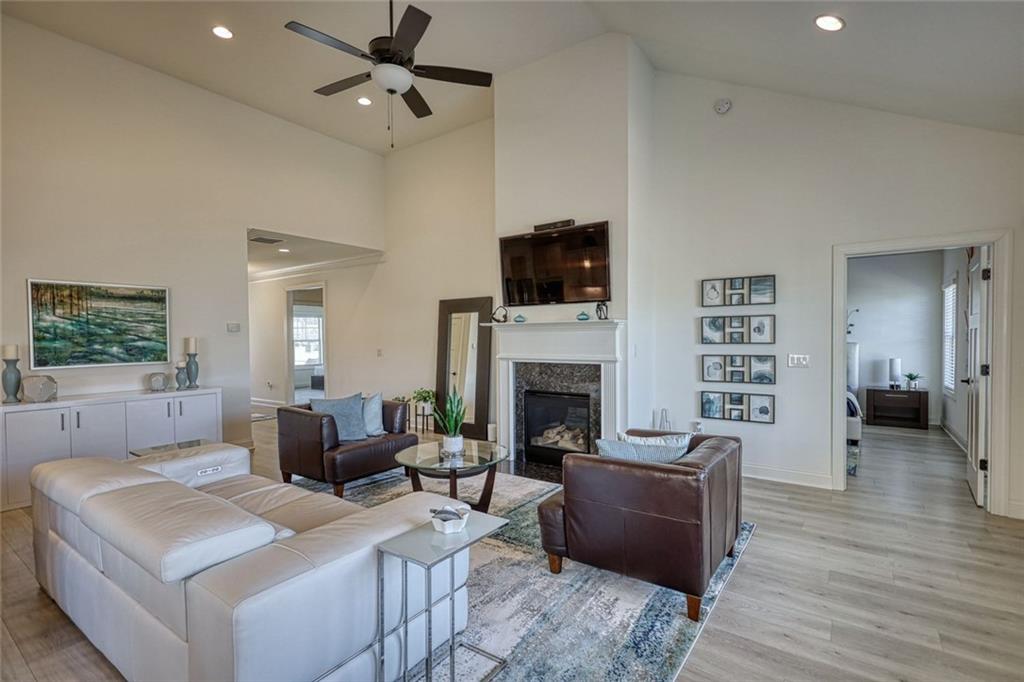 612 Haven Way Monroe, GA 30655 - Photo 6 of 44 a living room with furniture a fireplace and a flat screen tv
