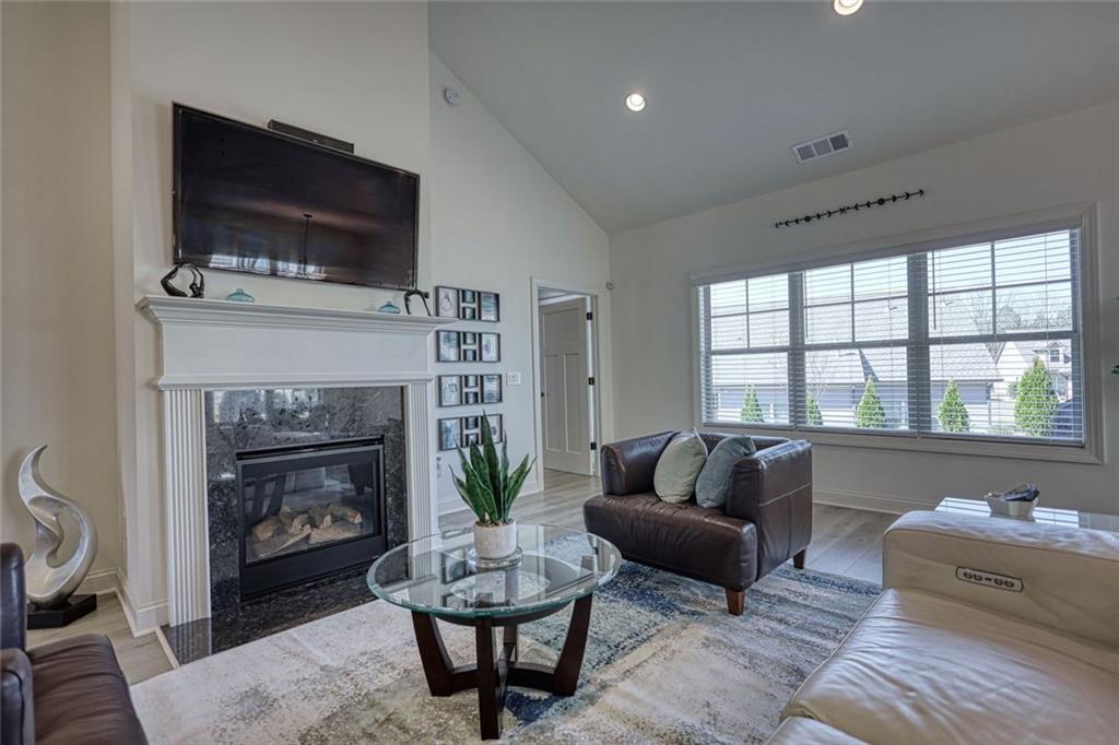 612 Haven Way Monroe, GA 30655 - Photo 7 of 44 a living room with furniture a flat screen tv and a fireplace
