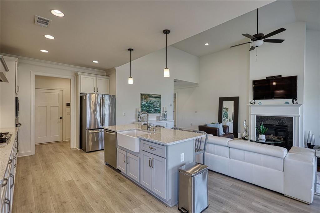 612 Haven Way Monroe, GA 30655 - Photo 9 of 44 a large white kitchen with a large center island and stainless steel appliances
