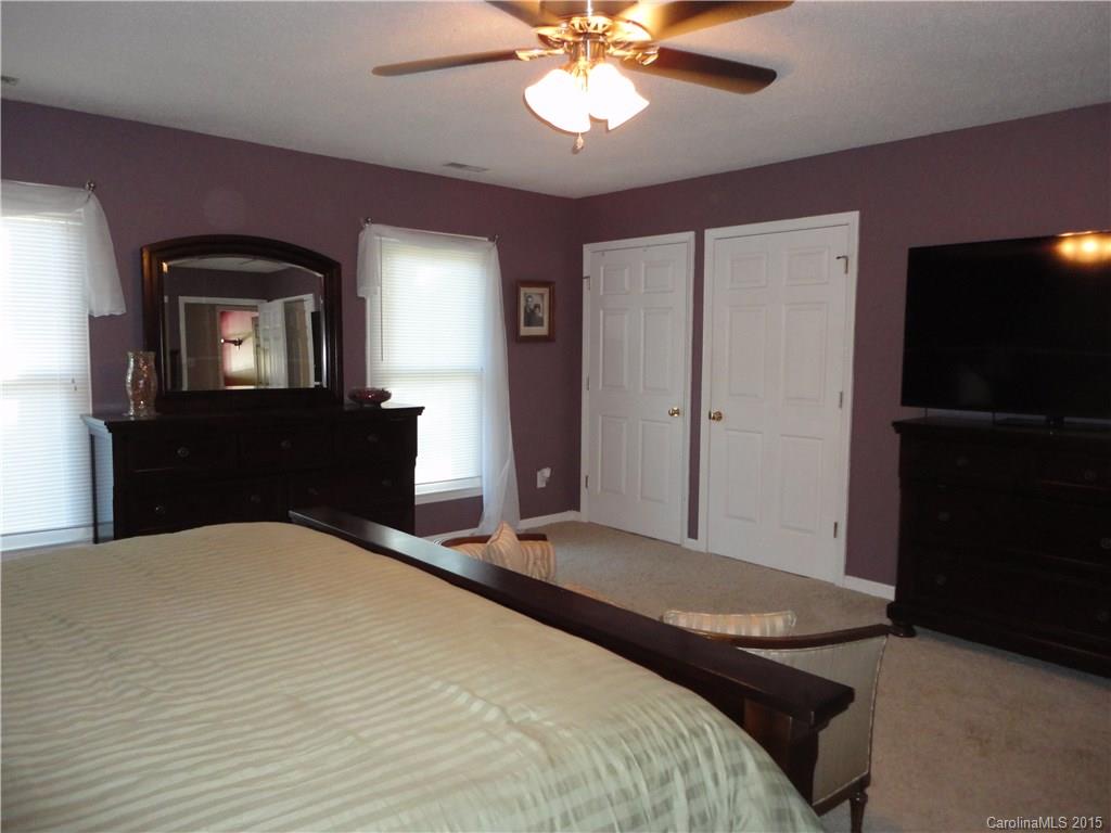952 Pleasant Ridge Road, Unit 31 Fort Mill, SC 29715 - Photo 11 of 23 a bedroom with a bed and a chandelier
