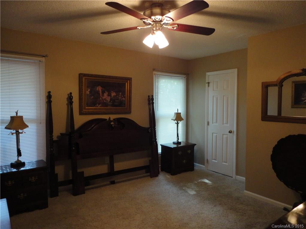 952 Pleasant Ridge Road, Unit 31 Fort Mill, SC 29715 - Photo 14 of 23 a bedroom with a bed and a chandelier