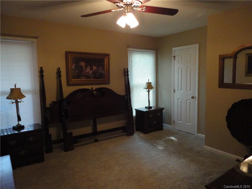 952 Pleasant Ridge Road, Unit 31 Fort Mill, SC 29715 - Photo 15 of 23 a bedroom with a bed and a chandelier