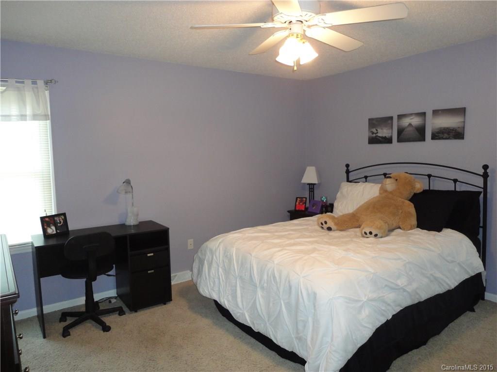 952 Pleasant Ridge Road, Unit 31 Fort Mill, SC 29715 - Photo 16 of 23 a bedroom with a bed and a chandelier