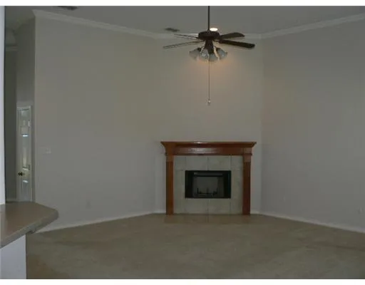 a view of an empty room with a fireplace