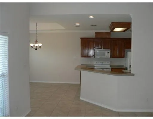 a kitchen with refrigerator and microwave