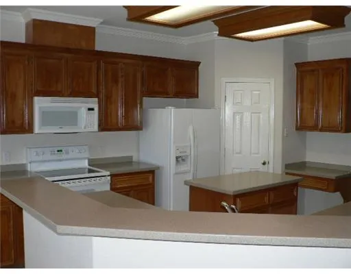 a kitchen with stainless steel appliances granite countertop a sink and a microwave