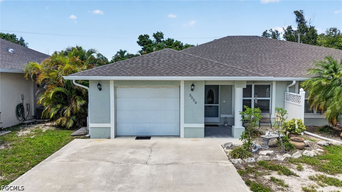 5520 Phillips Street Bokeelia, FL 33922 - Photo 1 of 50 a front view of a house with a garden