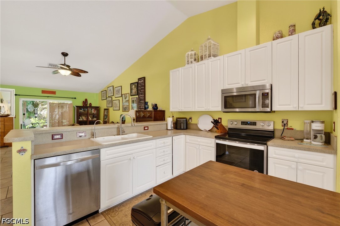 5520 Phillips Street Bokeelia, FL 33922 - Photo 13 of 50 a kitchen with a sink a stove and cabinets