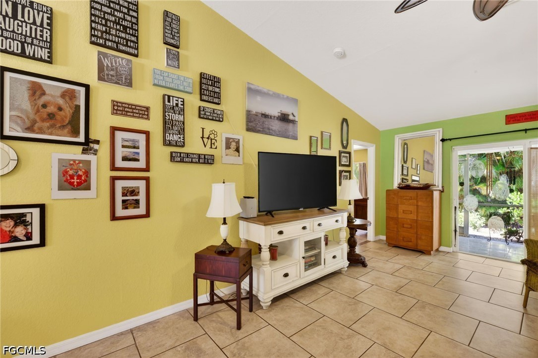 5520 Phillips Street Bokeelia, FL 33922 - Photo 18 of 50 a living room with fish tank and a flat screen tv