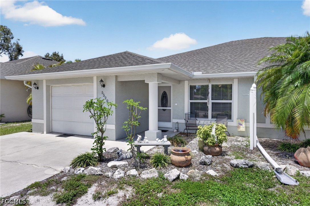 5520 Phillips Street Bokeelia, FL 33922 - Photo 2 of 50 a front view of a house with garden