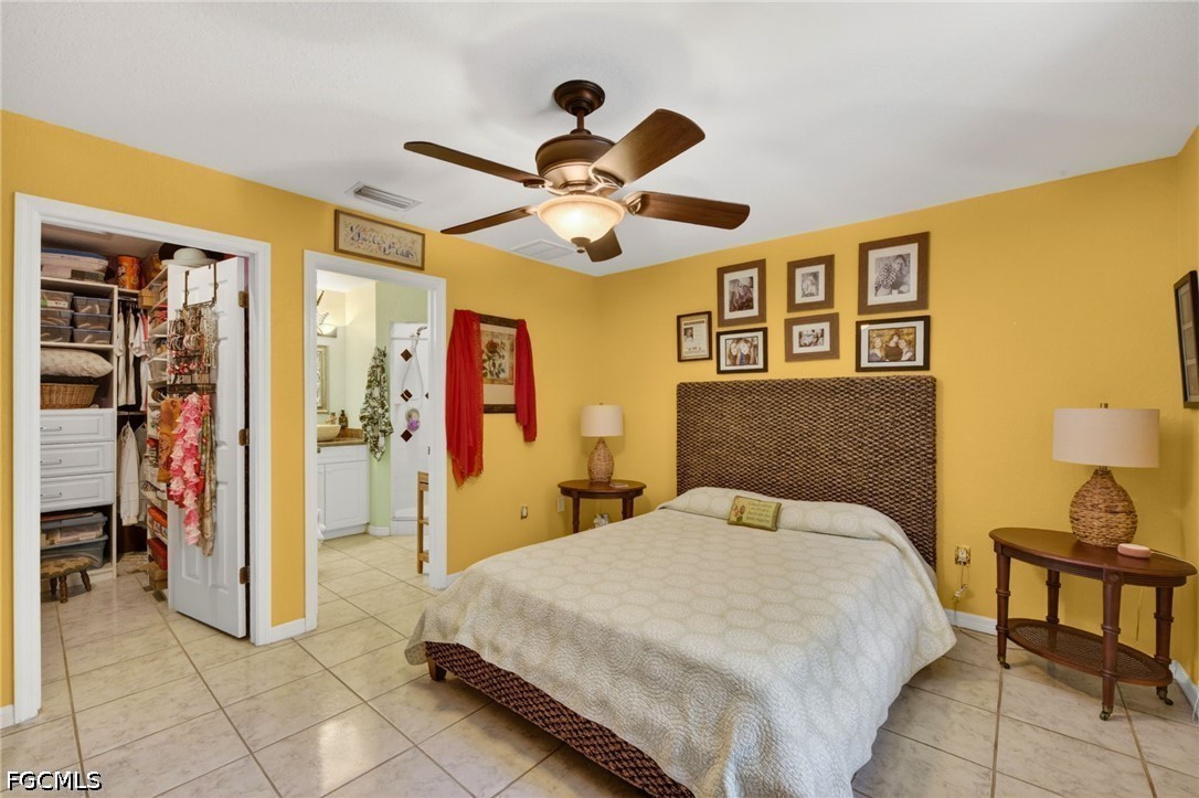 5520 Phillips Street Bokeelia, FL 33922 - Photo 22 of 50 a bedroom with a bed and a chandelier