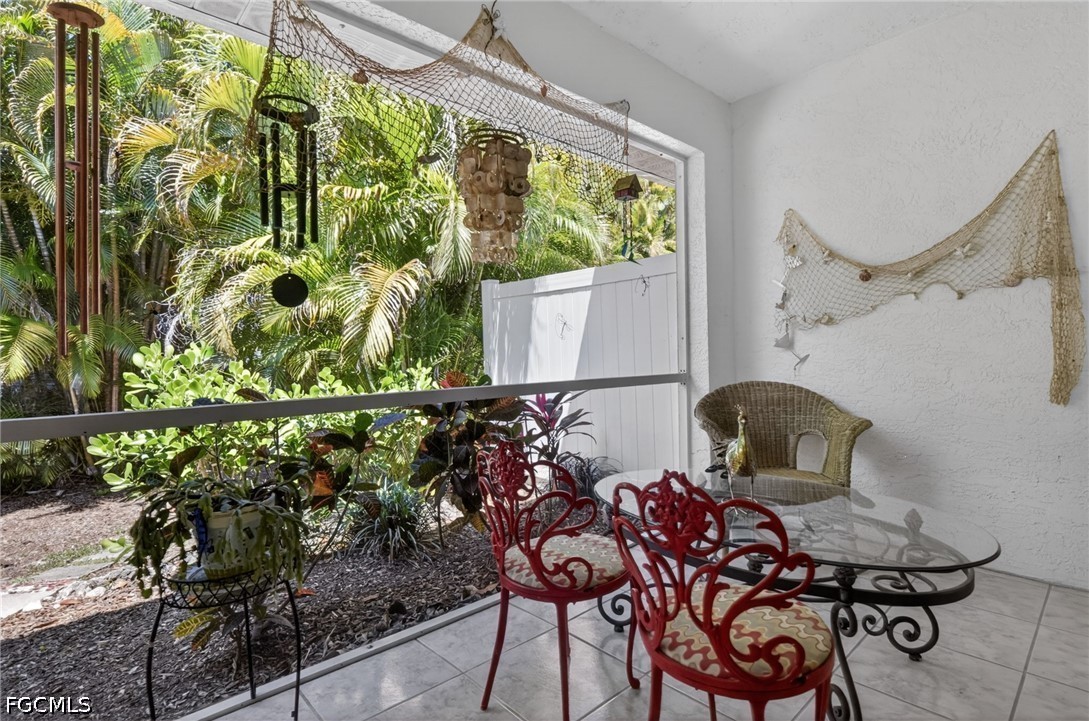 5520 Phillips Street Bokeelia, FL 33922 - Photo 26 of 50 a view of a chairs and table in a balcony
