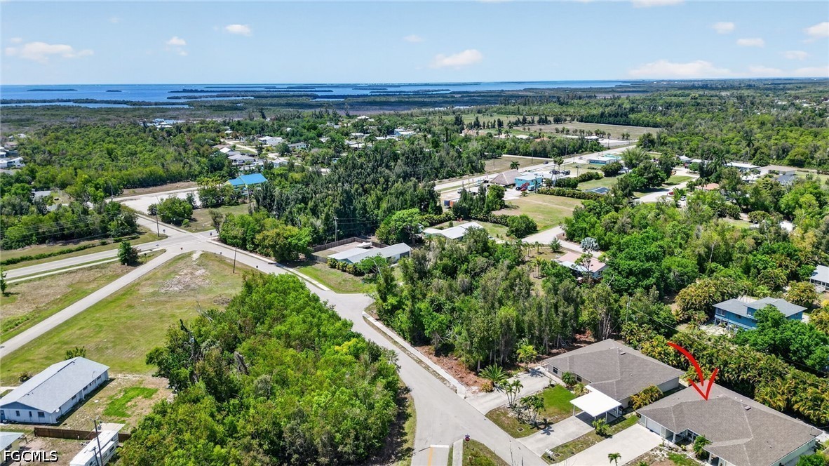 5520 Phillips Street Bokeelia, FL 33922 - Photo 35 of 50 an aerial view of a house with a yard and lake view