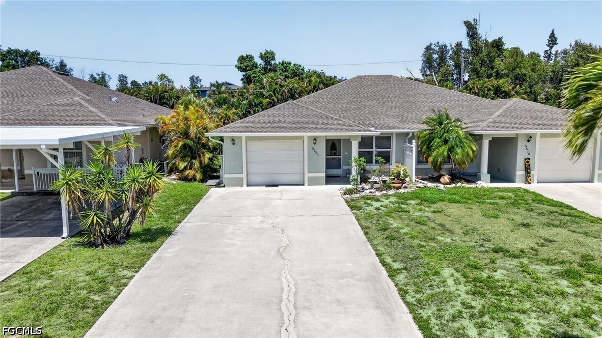 5520 Phillips Street Bokeelia, FL 33922 - Photo 43 of 50 a front view of a house with a garden