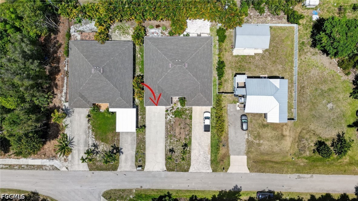 5520 Phillips Street Bokeelia, FL 33922 - Photo 46 of 50 an aerial view of a house with a yard and large tree
