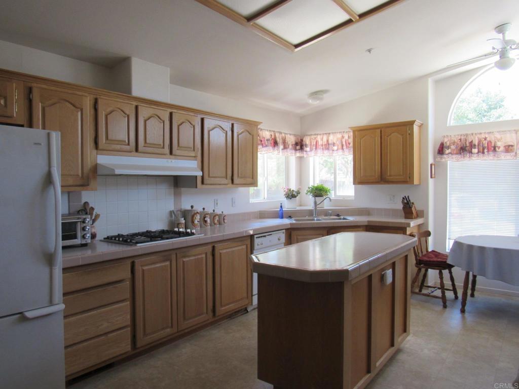 1124 Far Valley Road Campo, CA 91906 - Photo 4 of 21 a kitchen with granite countertop a sink and cabinets