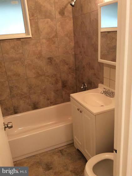 7527 Greenleaf Road Landover, MD 20785 - Photo 11 of 15 a bathroom with a sink a toilet and bathtub