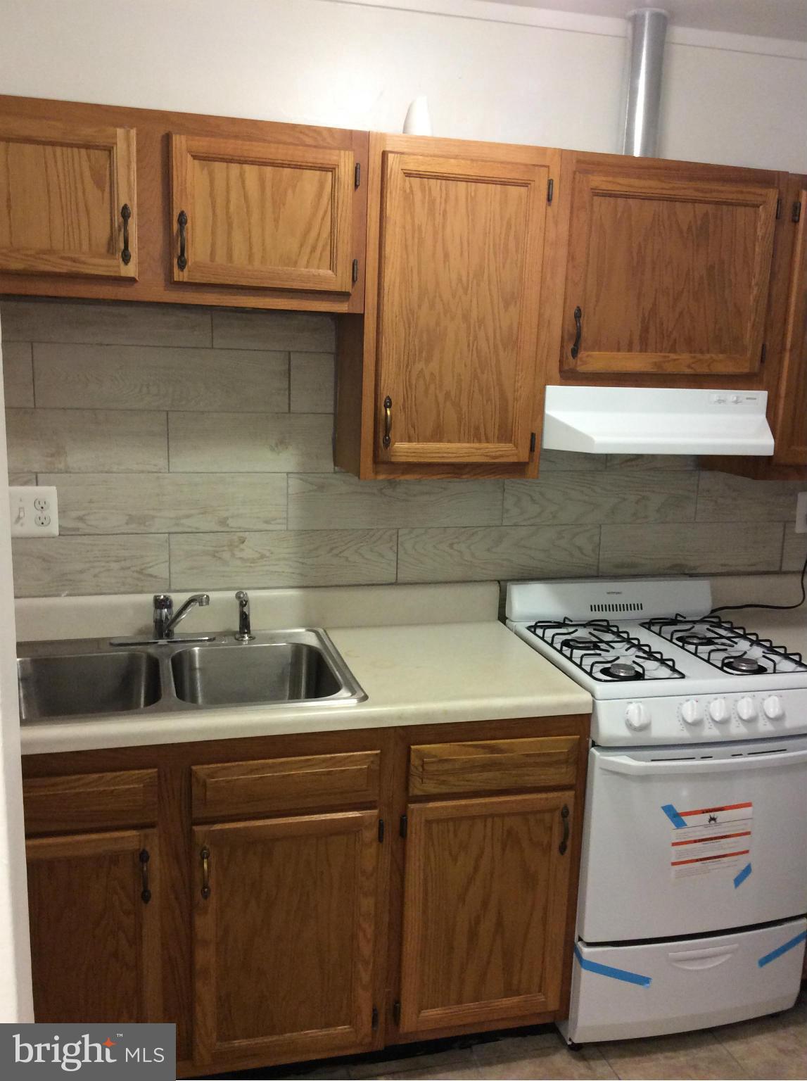 7527 Greenleaf Road Landover, MD 20785 - Photo 4 of 15 a kitchen with granite countertop a sink and a stove