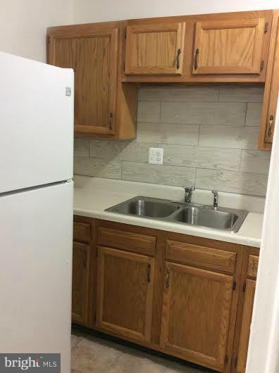 7527 Greenleaf Road Landover, MD 20785 - Photo 5 of 15 a kitchen with stainless steel appliances granite countertop a sink and a refrigerator
