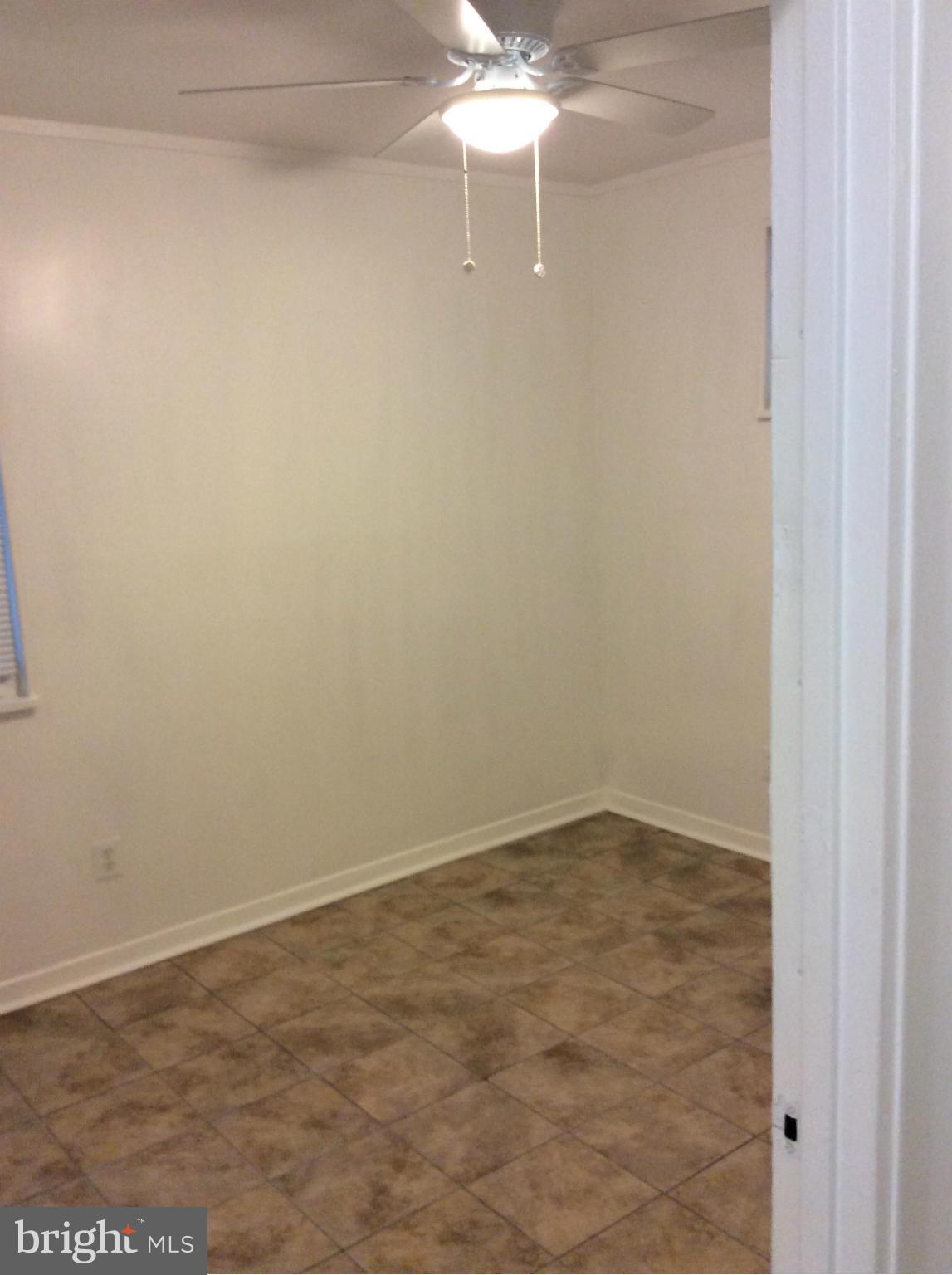 7527 Greenleaf Road Landover, MD 20785 - Photo 10 of 15 an empty room with a fan & a window