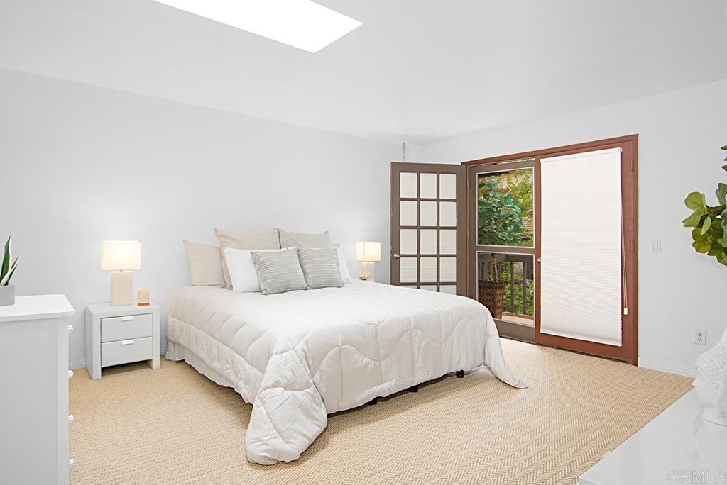 2372 Altisma Way, Unit C Carlsbad, CA 92009 - Photo 19 of 30 a bedroom with a bed and a large window