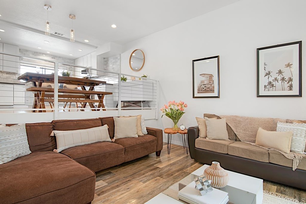 2372 Altisma Way, Unit C Carlsbad, CA 92009 - Photo 2 of 30 a living room with furniture and wooden floor