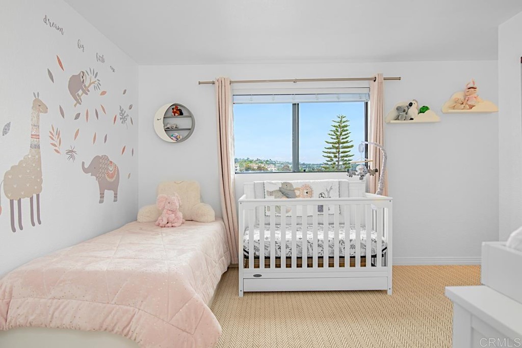 2372 Altisma Way, Unit C Carlsbad, CA 92009 - Photo 25 of 30 a bedroom with a bed and a window with wall paintings