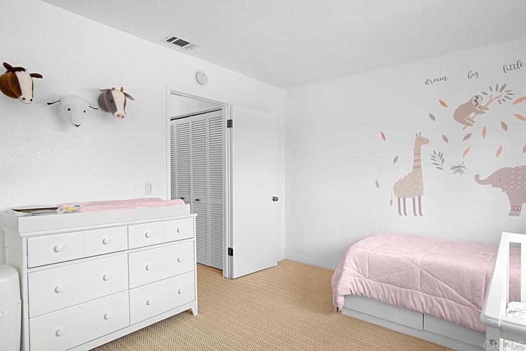 2372 Altisma Way, Unit C Carlsbad, CA 92009 - Photo 26 of 30 a bedroom with a bed and a dresser