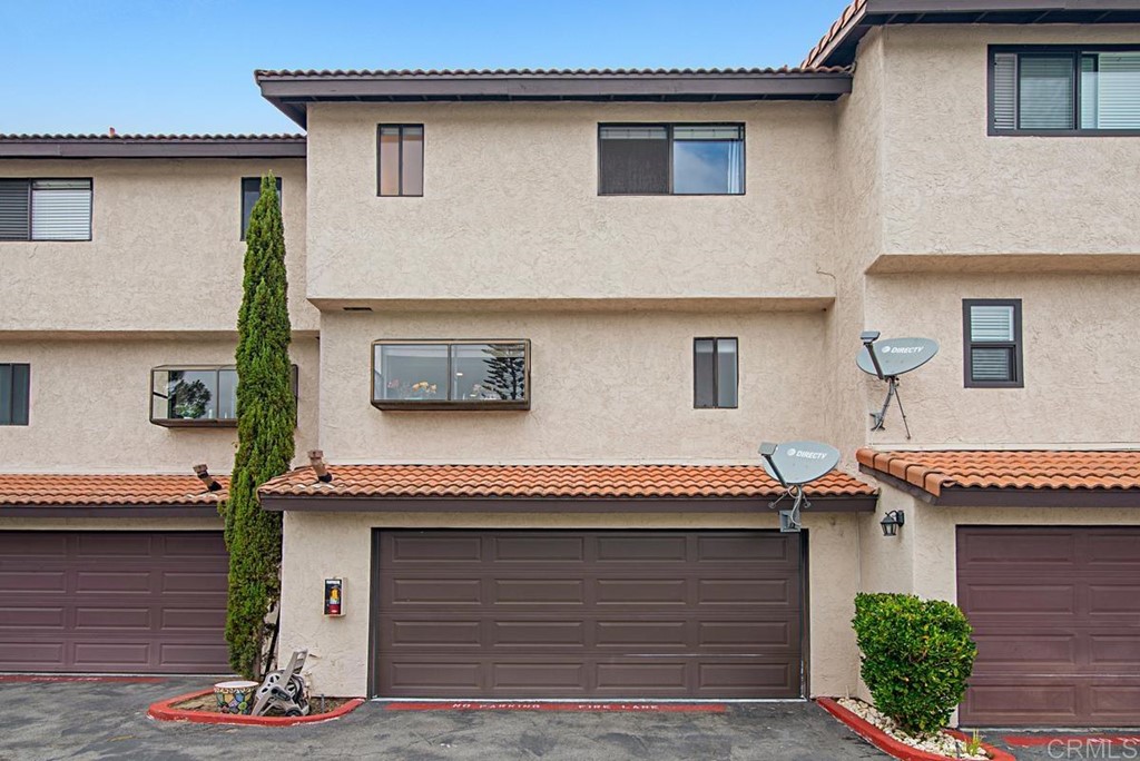 2372 Altisma Way, Unit C Carlsbad, CA 92009 - Photo 29 of 30 a front view of a house with a garden