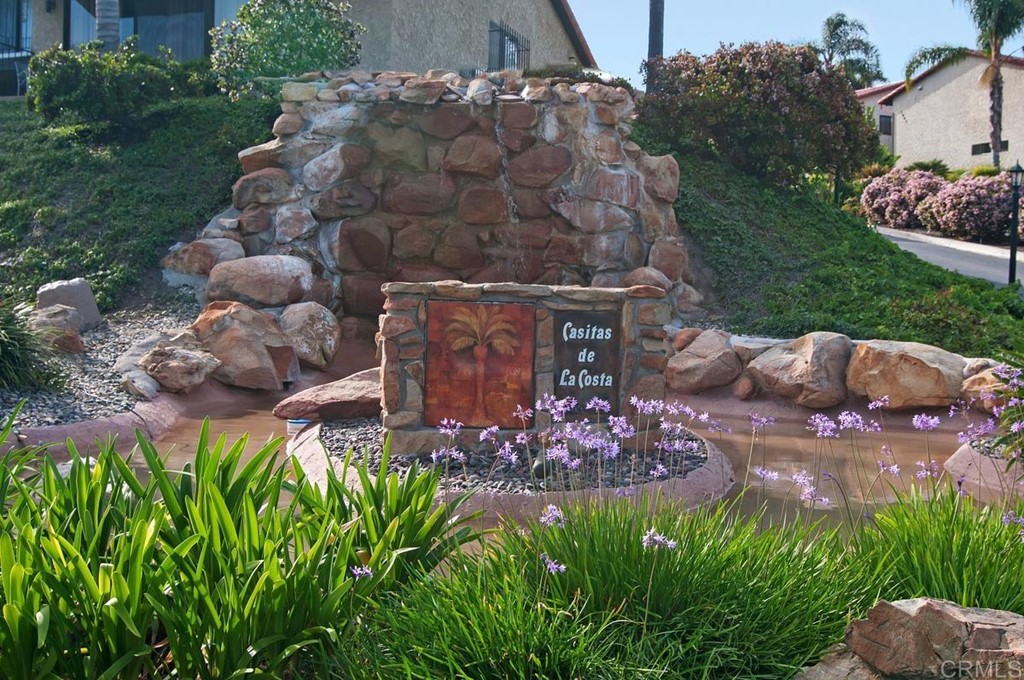 2372 Altisma Way, Unit C Carlsbad, CA 92009 - Photo 30 of 30 a view of a backyard with plants and outdoor seating