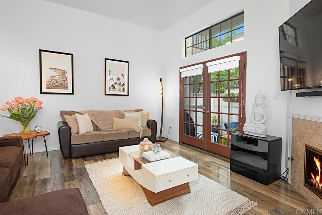 2372 Altisma Way, Unit C Carlsbad, CA 92009 - Photo 3 of 30 a living room with furniture a flat screen tv and a fireplace