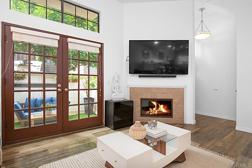 2372 Altisma Way, Unit C Carlsbad, CA 92009 - Photo 4 of 30 a living room with a fireplace and a flat screen tv