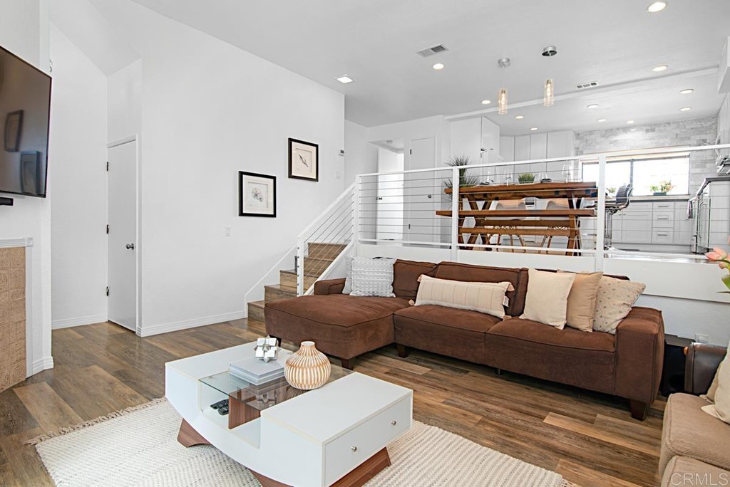 2372 Altisma Way, Unit C Carlsbad, CA 92009 - Photo 5 of 30 a living room with furniture and a wooden floor