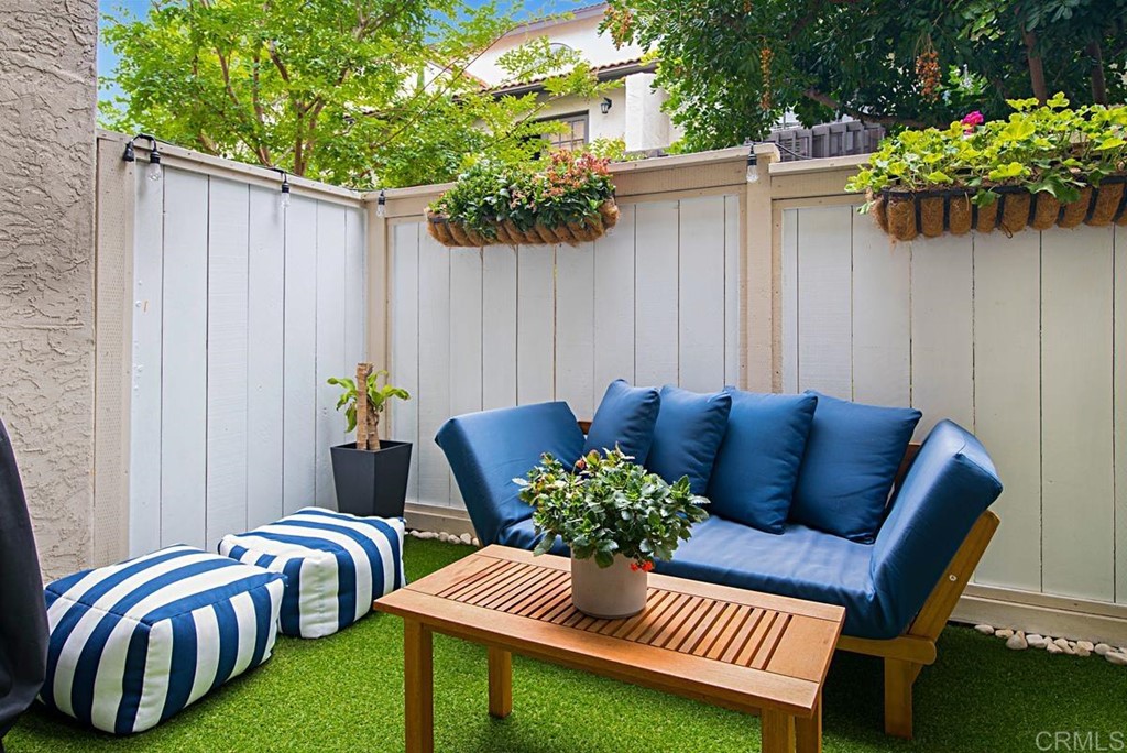 2372 Altisma Way, Unit C Carlsbad, CA 92009 - Photo 7 of 30 a view of a backyard with furniture and a garden