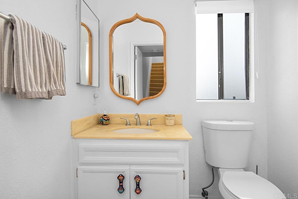 2372 Altisma Way, Unit C Carlsbad, CA 92009 - Photo 8 of 30 a bathroom with a toilet sink and mirror