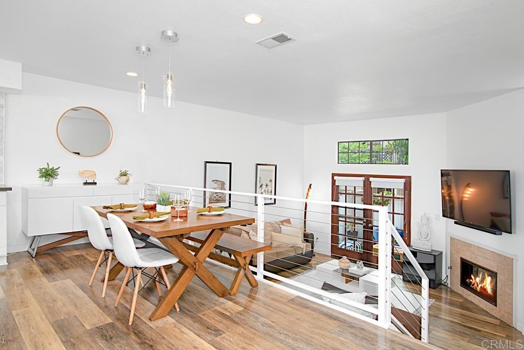 2372 Altisma Way, Unit C Carlsbad, CA 92009 - Photo 9 of 30 a view of a dining room with furniture and wooden floor