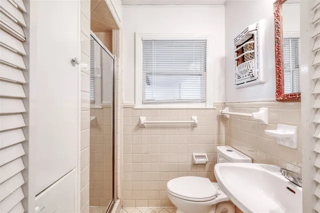 a white toilet sitting next to a bathroom sink