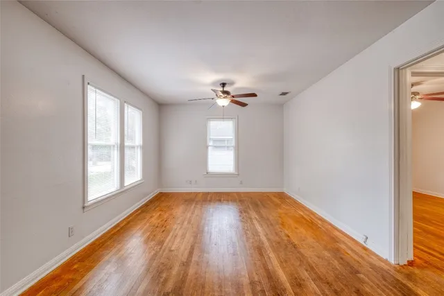 wooden floor in an empty room with a window