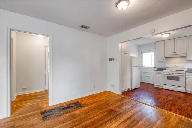 a view of a kitchen with wooden floor and a sink